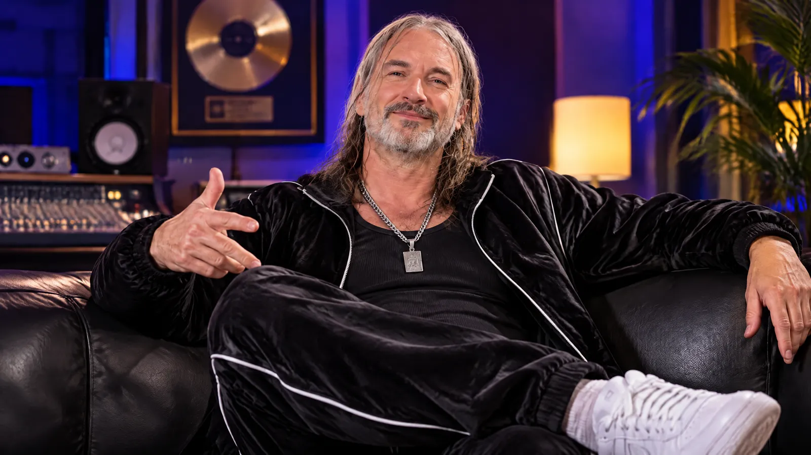 Cloud9 relaxing on a leather couch in a recording studio